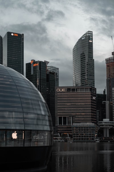 Glass building of cloudy skies during the day
